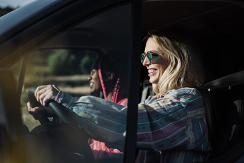 Young friends driving a car