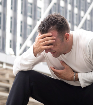 Man having health problems on a street, kratom use effects.