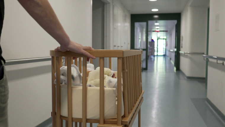 Newborn in a hospital hallway