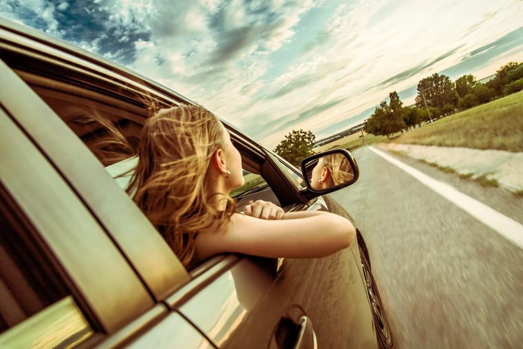 Woman is traveling in a car