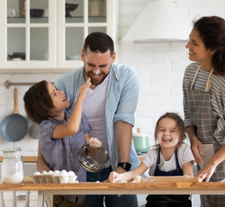 Happy family cooking and playing together in a kitchen