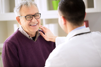 Happy elderly with a doctor