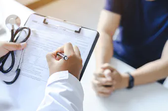 A Doctor writing out a prescription