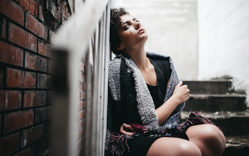 Woman crying on the stairs