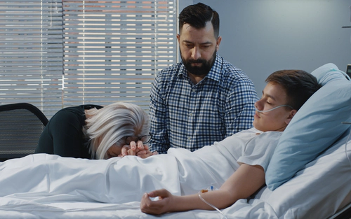 Family around a young boy hospitalized