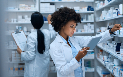 Pharmacy staff checking shelves